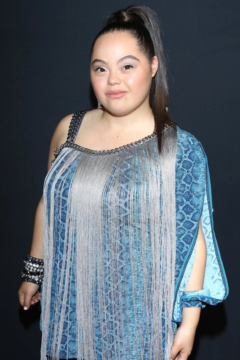 Madison in a beautiful blue sequined dress looking at the camera.
